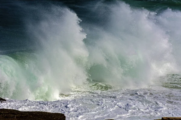 Wave crashing against rocks