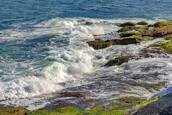 Água do mar salpicando sobre as pedras — Fotografia de Stock