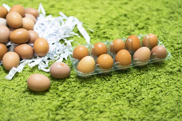 The packaging material for eggs. Material Green Paper,Eggs with green background, select focus