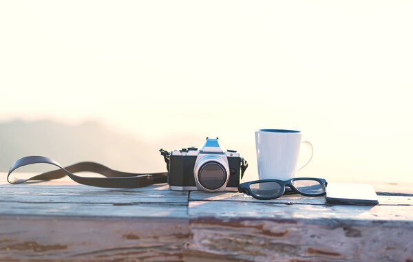 Coffee cup on the table in the morning.Cup with tea on table over mountains landscape with sunlight vintage. Beauty nature background