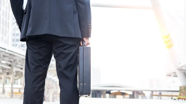Businessman holding a business briefcase.businessman holding briefcase and going to work time
