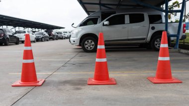 Plastic signaling traffic cone encloses a place in the parking lot for trucks,Orange cones used to close off a street,traffic con clipart
