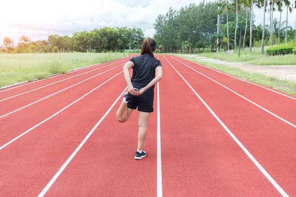 Corredor Jovem Mulher Esticando Pernas Antes Correr Durante Manhã Ensolarada — Fotografia de Stock