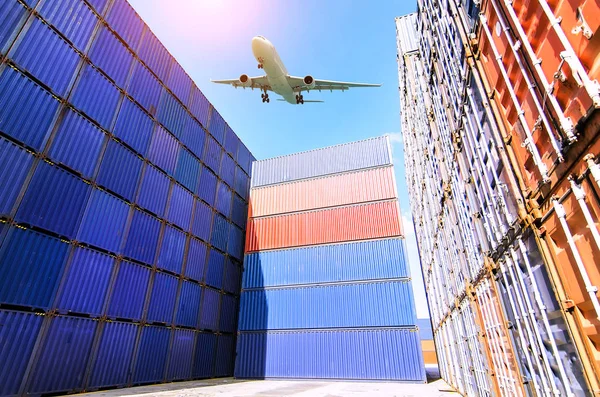 Forklift truck lifting cargo container in shipping yard or dock yard against sunrise sky with cargo container stack in background for transportation import,export and logistic industrial concept