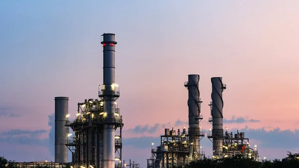 Gas turbine electrical power plant at dusk with orange sky