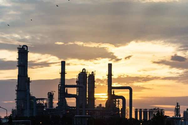 Gas turbine electrical power plant at dusk with orange sky