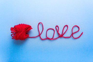 Word Love made of wool and red clew