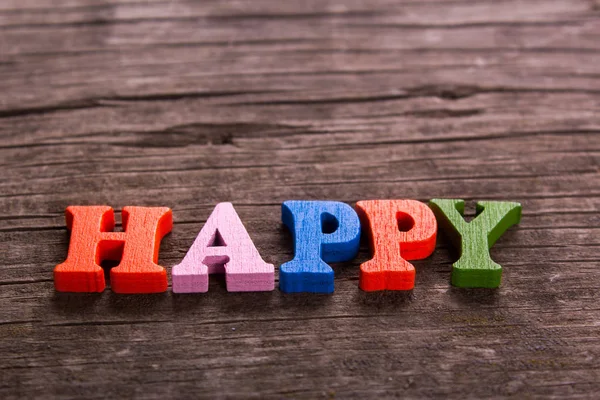 Palavra feliz feito de letras de madeira — Fotografia de Stock