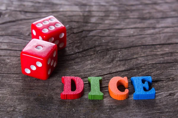 red dice word on a wooden table