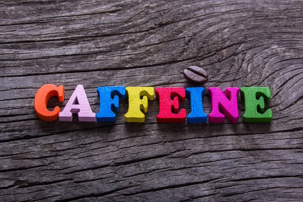 Parola caffeina e chicchi di caffè — Foto Stock