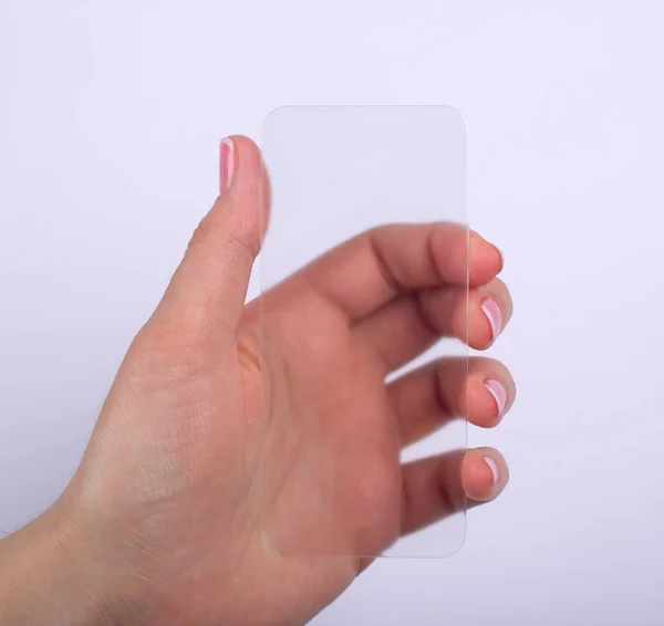 Telefone de vidro transparente na mão — Fotografia de Stock