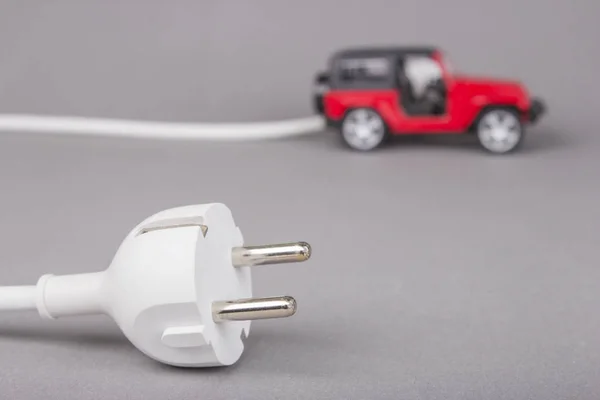 Electric car with plug from the outlet. — Stock Photo, Image