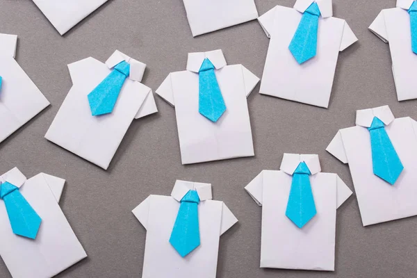 Office workers in a shirt and tie made of paper. Origami. Copy space for text.