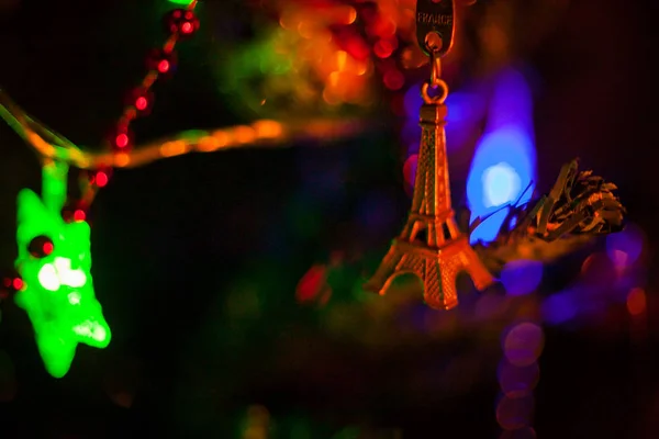 New Years wish. toy eiffel tower on christmas tree