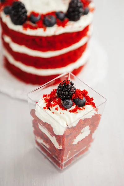 homemade portioned dessert red velvet decorated with berries on a light wooden background. valentine\'s day dessert