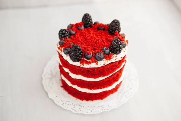 homemade portioned dessert red velvet decorated with berries on a light wooden background. valentine's day dessert