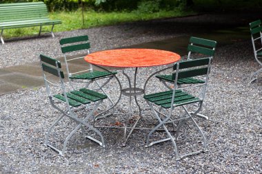 açık havada yağmur gün oturaklı kırmızı yuvarlak masa