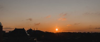 Şehirde gün doğumu. Güzel turuncu gün batımı fotoğrafı, Lübnan şehrinin gündoğumundaki silueti. Sıcak hava, romantik tatil, tatil konsepti