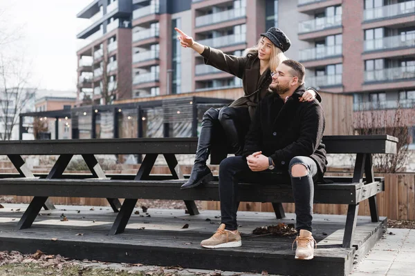 Loving couple relaxing outdoor. Cute couple of hipsters is walking in spring park. Beautiful sunny day. Walking on the city\'s street, spring evening. Home purchase concept