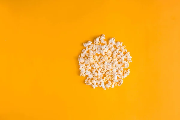 Popcorn in the shape of record button on yellow background. Flat lay banner, top view. To go to the cinema. I like watching films.