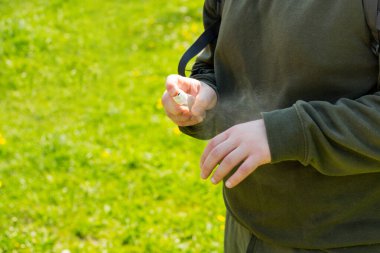 Yıkanmış el dezenfektanı kullanan erkek elleri Novel Coronavirus 'a ya da Corona Virüs Hastalığı' na karşı şehir parkının arka planında. Antiseptik ve Sağlık Konsepti