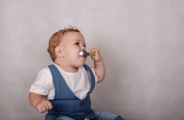 Bebé europeo apariencia come gachas de una cuchara — Foto de Stock