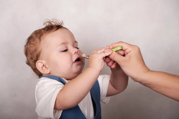 Ребенок европейский внешний вид ест кашу с ложки — стоковое фото