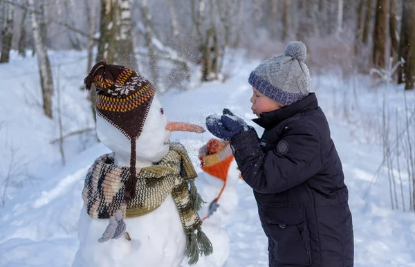 Söt Europeiska Pojke Och Rolig Snögubbe Snöiga Skogen Vinterdag Snön — Stockfoto