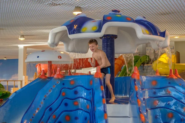 Happy boy on the water Park slide — Stock Photo, Image