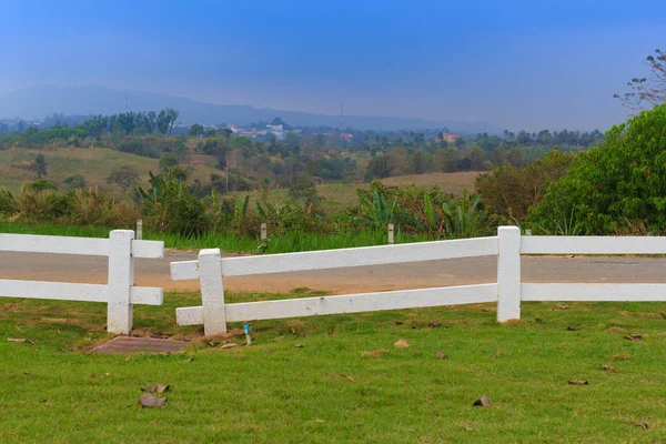 White fence on green lawn — Stock Photo, Image