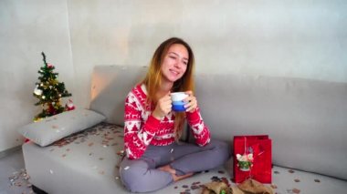 Young Girl Portrait Smile to Camera, Look Drink Tea Coffee Christmas Tree Bokeh Xmas Eve Lights New Year Confetti