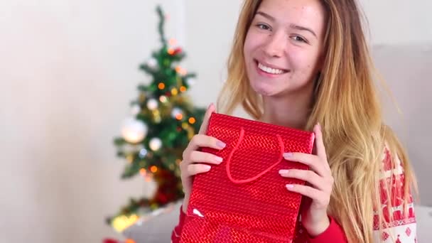 Young Girl Uses Hand Hold Get Gift, Surprise Smile to Camera Christmas Tree on Bokeh Xmas Eve Lights New Year Tree — Stock video