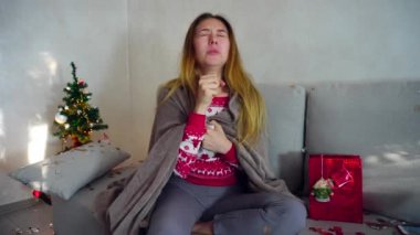 Genç kız portre üzücü hasta soğuk kış virüs ateş Noel ağacı Bokeh Noel arifesi ışıklar yeni yıl konfeti arka plan üzerinde evde