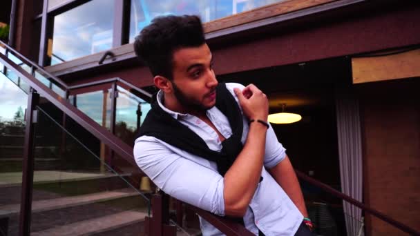 Cute Arab Guy Is Leaning On Stairs And He Winks Greeted Looking Into Camera Cute Arab Guy Is Leaning On Stairs And He Winks Greeted Looking Into Camera