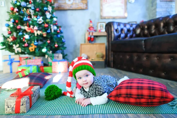 Cute baby lying on plaid among gifts background — Stock Photo, Image