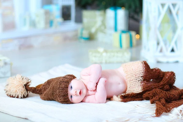 Kojenecká baby leží na dece v klobouku s bubo. — Stock fotografie