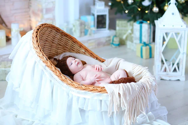 Small baby lying in cradle in Christmas white studio. — Stock Photo, Image