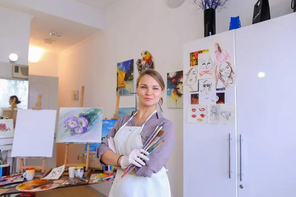 Women beautiful painter posing and smiling, laughing into camera