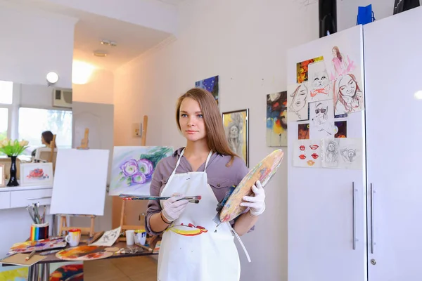 Women beautiful painter posing and smiling, laughing into camera