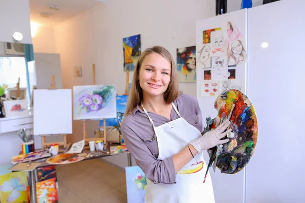 Women beautiful painter posing and smiling, laughing into camera