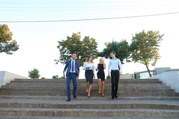 Beautiful confident people, two boys and two girls, smiling, hol