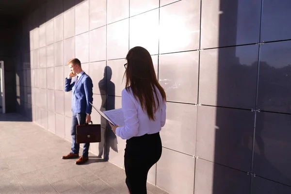 Joven guapo, hombre de negocios hablando por teléfono pasa por beaut — Foto de Stock