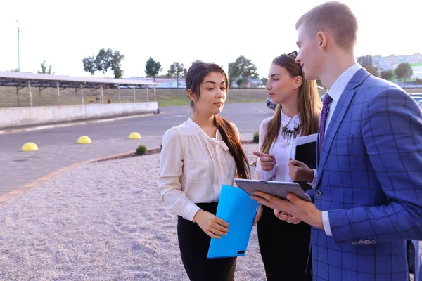 Three young successful businessman, students communicate, smilin