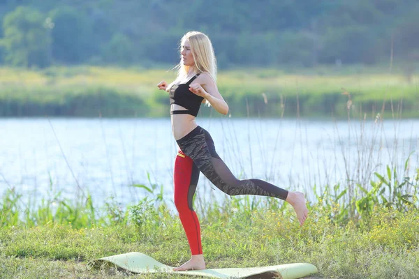 Young beautiful woman squats shows result press on stomach workout training wearing top