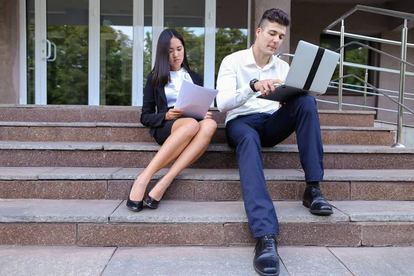 Attractive confident people, Caucasian boy and asian girl entrep