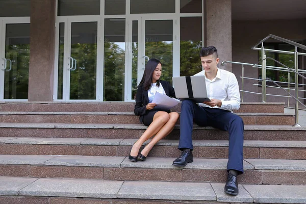 Attractive confident people, Caucasian boy and asian girl entrep