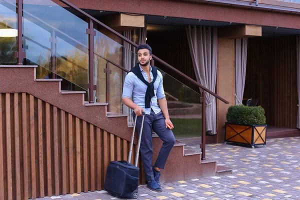 Atraente jovem árabe de pé com mala na mão e p — Fotografia de Stock