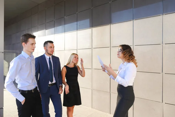 Girl in white blouse holds paper and explains, makes remarks, ex