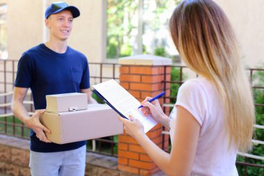 Postman Giving Pen And Documents to Girl, Woman Puts Signature a clipart