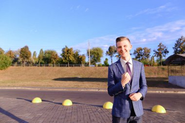 Sevimli genç adam işadamı, öğrenci standları önünde camer